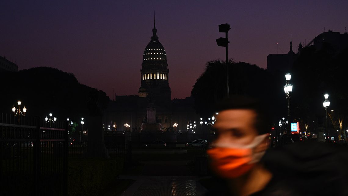 A man walks in front of the national Congress building during the lockdown imposed by the government to tackle the spread of the new Coronavirus, Covid-19, in Buenos Aires on June 9, 2020.