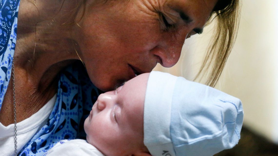 Andreo Diez holds Ignacio, her baby born via a Ukrainian surrogate mother for the first time, after spending two weeks in quarantine, due to the coronavirus outbreak, in a hotel where the Biotexcom clinic, the country's largest surrogate operation, puts up clients