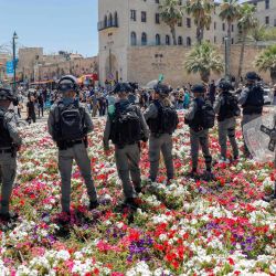 Las fuerzas de seguridad israelíes se reúnen cuando hombres árabes israelíes (invisibles) realizan la oración del viernes al mediodía antes de salir a las calles de la ciudad costera israelí de Jaffa, al sur de Tel Aviv, para protestar contra una decisión tomada por el municipio de Tel Aviv-Jaffa para demoler un Cementerio musulmán del siglo XVIII para construir un nuevo refugio para personas sin hogar y espacio comercial en el sitio. | Foto:AHMAD GHARABLI / AFP