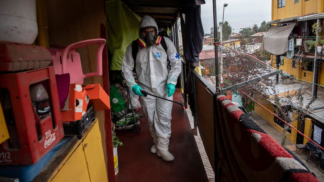A municipal worker cleans and disinfects a low-income neighbourhood in Santiago, on June 16, 2020.
