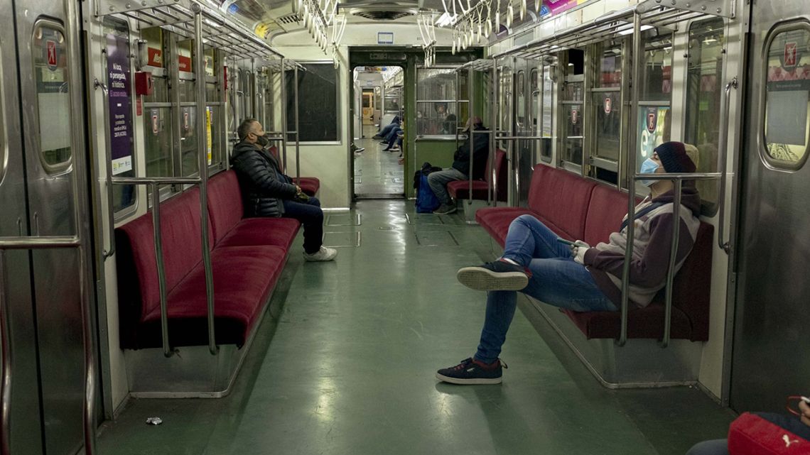 Passengers wearing protective masks sit in a Subte underground carriage in the capital.