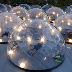 Personas participan en una clase de yoga al aire libre en el Hotel X, dentro de domos para cumplir con las medidas de distanciamiento social para controlar la propagación de Covid-19, en Toronto, Canadá.  | Foto:Cole Burston / Getty Images / AFP