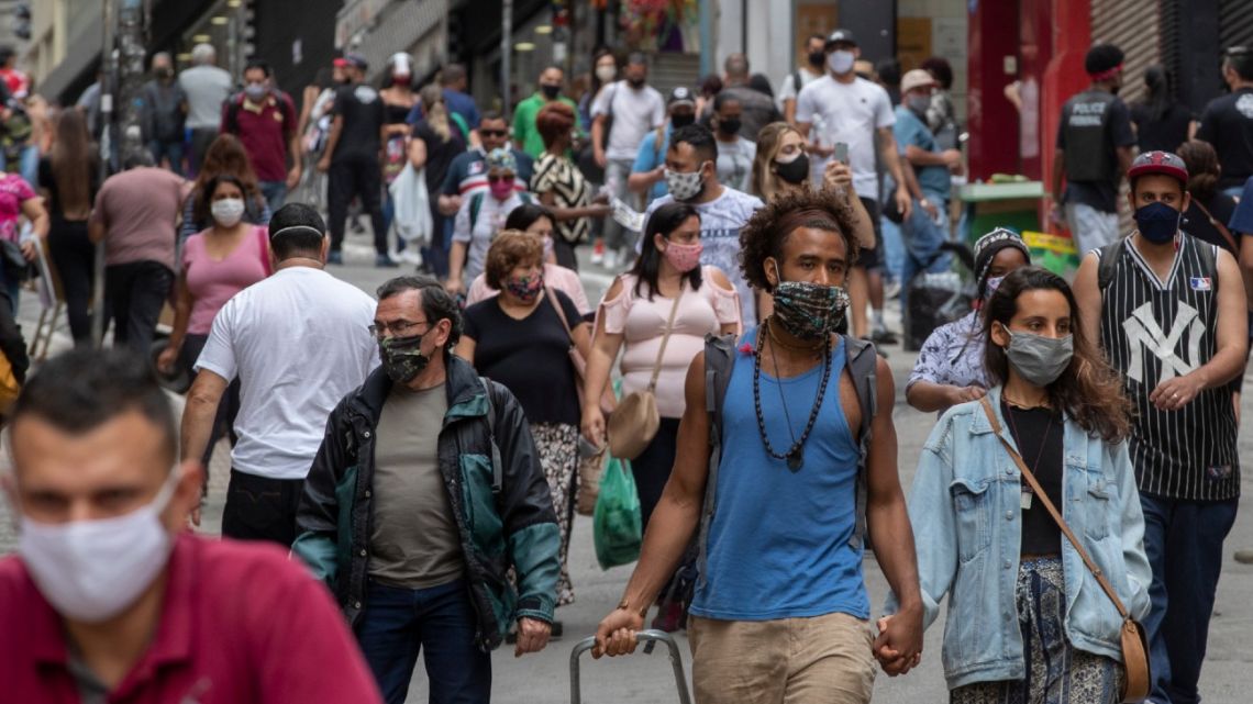 Pedestrians walk through a downtown shopping district in Sao Paulo, Brazil on June 10, 2020.