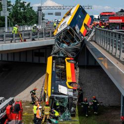 Las fuerzas de rescate trabajan en el lugar del accidente donde un autobús se cayó de un viaducto en Varsovia, Polonia. Las autoridades locales confirmaron que una persona murió y otras 20 resultaron heridas. | Foto:Wojtek Radwanski / AFP