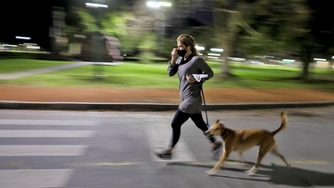 A woman running with her dog. 