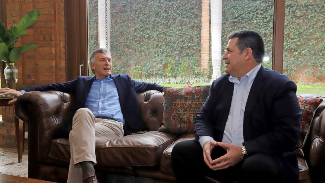 In this photo released by Horacio Cartes' press office, the former Paraguay president, right, listens to Argentina's former leader Mauricio during a meeting at the former's house in Asunción, Monday, July 13, 2020.