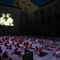 La gente mira una proyección de video en la  | Foto:CLEMENT MAHOUDEAU / AFP