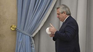 President Alberto Fernández takes off his face mask before delivering a speech in Buenos Aires on July 22, 2020.