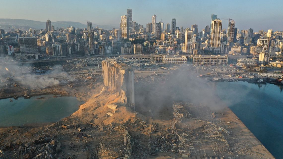 A drone picture shows the scene of an explosion at the seaport of Beirut, Lebanon, Wednesday, August 5, 2020. A massive explosion rocked Beirut on Tuesday, flattening much of the city's port, damaging buildings across the capital and sending a giant mushroom cloud into the sky. More than 70 people were killed and 3,000 injured, with bodies buried in the rubble, officials said.