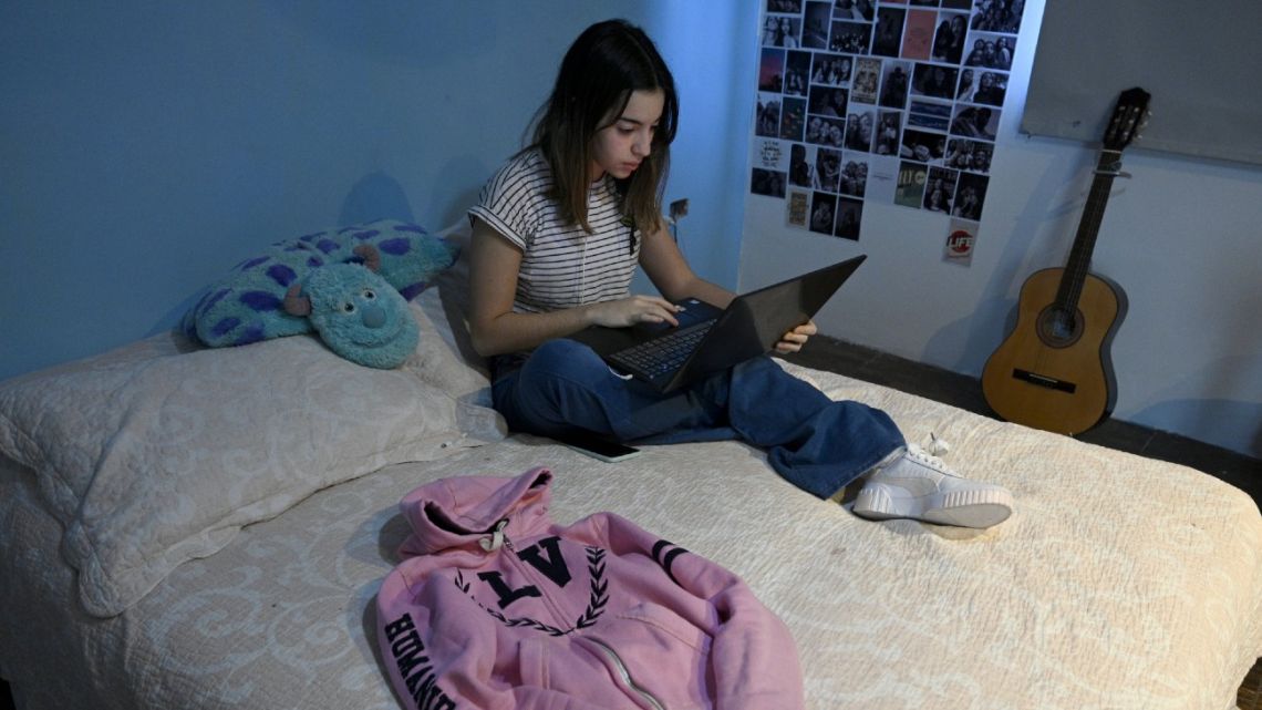 High school student Jazmín Islas poses at her bedroom in La Plata, Buenos Aires.
