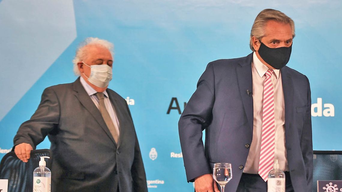 President Alberto Fernández and Health Minister Ginés González García, wearing face masks, arrive for a press conference about production of a coronavirus vaccine.