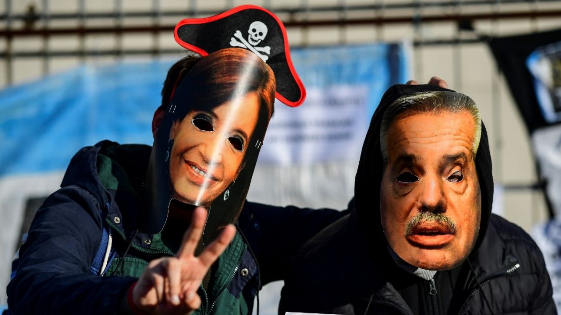 Two men wear masks depicting President Alberto Fernández and Vice-President Cristina Fernández de Kirchner during an anti-government protest at Avenida 9 de Julio, in Buenos Aires, Argentina, on August 17, 2020.
