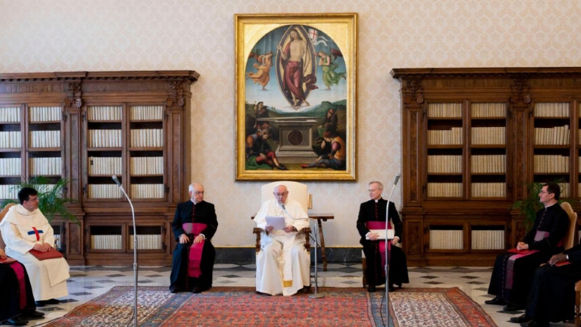 Pope Francis (C), flanked by Monsignor Leonardo Sapienza (L) and Monsignor Luis Maria Rodrigo Ewart, speak during a live-streamed weekly private audience from the library of the apostolic palace in the Vatican during the Covid-19 coronavirus pandemic.