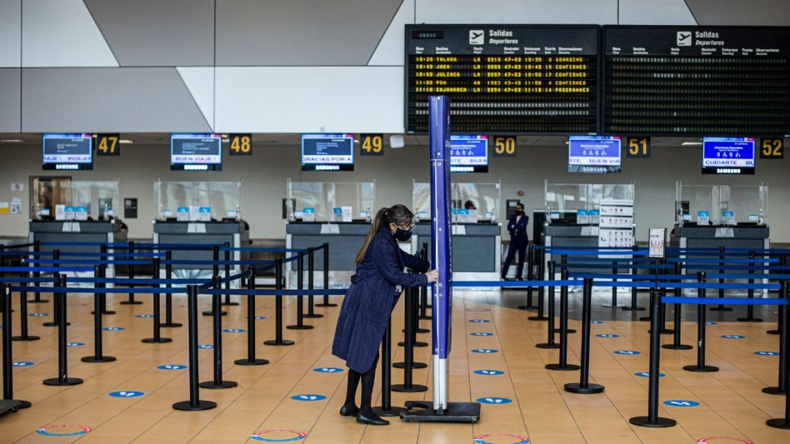 In this file photo taken on July 17, 2020 an airport worker is seen at the international airport Jorge Chavez in Lima. 