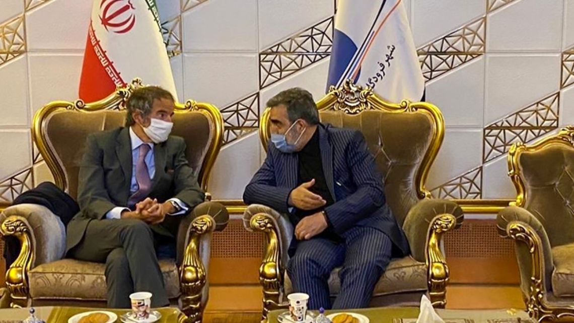 A handout picture released by Iran's Atomic Energy Organisation on August 24, 2020 shows the organisation's spokesman Behrouz Kamalvandi (right) speaking with the Director General of the International Atomic Energy Agency (IAEA), Rafael Mariano Grossi (left) upon his arrival at the Imam Khomeini International airport in Tehran.