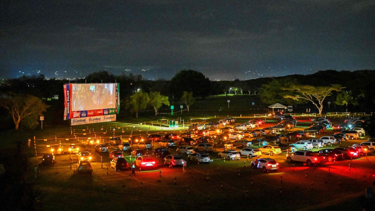 La gente ve una película desde sus autos estacionados a una distancia social segura, en un nuevo autocine, en medio del nuevo coronavirus, la pandemia COVID-19, en Cali, Colombia. | Foto:Luis Robayo / AFP