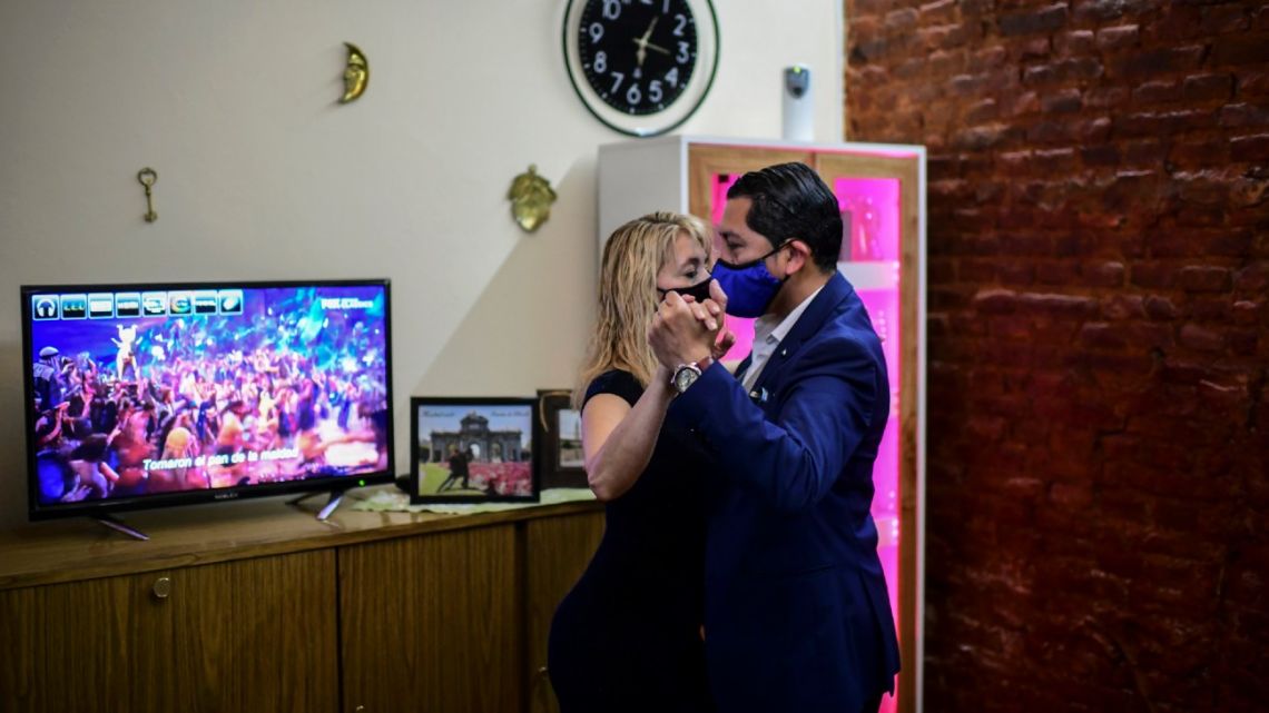 Veronica Pascual (left) and Sergio Saucet dance tango in their house in Buenos Aires, on August 24, 2020. Saucet and Pascual are competitors in the Tango Dance World Championship that takes place in the city of Buenos Aires. Dancers from all over the world will compete from Wednesday in an unprecedented virtual tango world organized by the Buenos Aires City Hall.