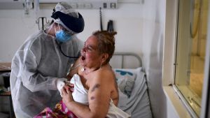 A patient infected with the new coronavirus is treated by a doctor at the Doctor Alberto Antranik Eurnekian Public Hospital in Ezeiza.