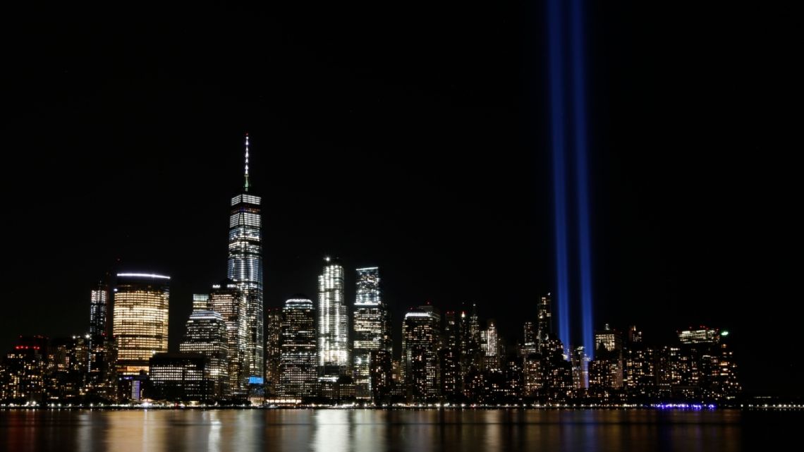 In this Septembber 11, 2017 photo, the Tribute in Light illuminates in the sky above the Lower Manhattan area of New York, as seen from across the Hudson River in Jersey City, New Jersey, US.