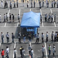 Corea del Sur. Los empleados de Hyundai Heavy Industries esperan en filas para tomar las pruebas del coronavirus COVID-19 en una estación de pruebas de virus en la ciudad portuaria de Ulsan, en el sureste del país, después de que siete personas, incluidos los empleados de la compañía y sus familiares, fueran confirmados como nuevos casos de coronavirus. | Foto:YONHAP / AFP