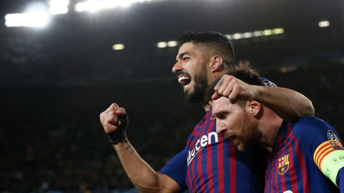 In this file photo taken on March 13, 2019, Barcelona's Argentine forward Lionel Messi (right) celebrates a goal with Barcelona's Uruguayan forward Luis Suárez.