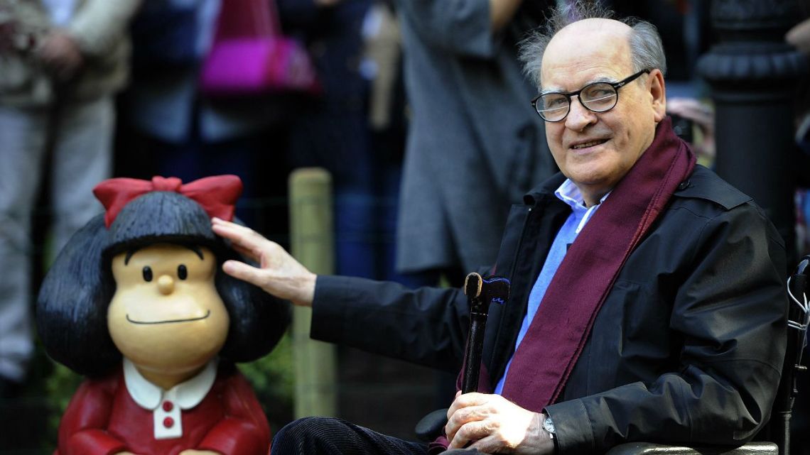 Quino, the creator of 'Mafalda' comic, pictured next to a model of his creation.