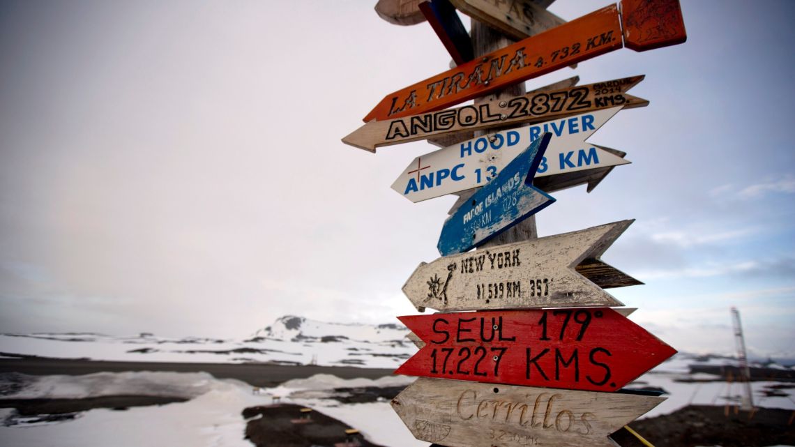 In this January 20, 2015 file photo, wooden arrows show the distances to various cities on King George Island, Antarctica. 