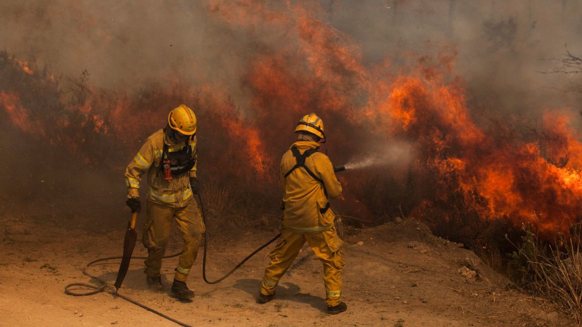 Firefighters work to put out in fires in Villa Giardino, Córdoba Province, Tuesday, September 22, 2020.