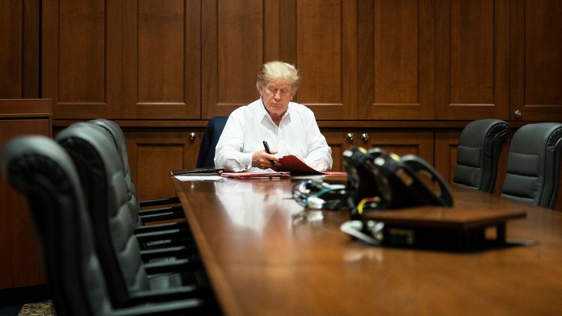In this image released by the White House, US President Donald Trump works in his conference room at Walter Reed National Military Medical Center in Bethesda, Saturday, October 3, 2020, after testing positive for Covid-19.