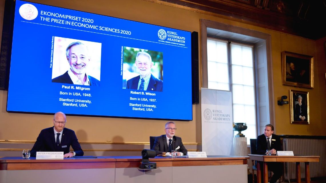 Peter Fredriksson, Chairman of the Committee for Economic Sciences, left, Goran K. Hansson, Permanent Secretary for the Royal Swedish Academy of Sciences, center, and Tommy Andersson, member in The Prize Committee for the Alfred Nobel Memorial Prize in Economic Sciences announce the Sveriges Riksbank Prize in Economic Sciences in Memory of Alfred Nobel for 2020 at a press conference in Stockholm, Monday Oct. 12, 2020. 