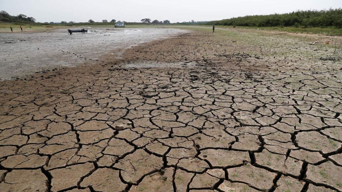 Cracked earth is exposed in the riverbed of the Paraguay River in Chaco-i near Asuncion city, Paraguay, Thursday, Oct. 8, 2020. The Paraguay River reached its lowest level in 50 years on Friday, Oct. 9, 2020, following months of extreme drought that has exposed the nation’s economic dependence on the river and limited access to drinking water.