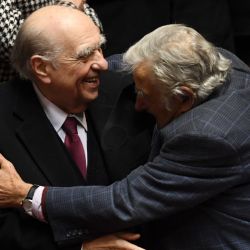 Uruguayan former presidents Julio Sanguinetti (left) (1985-1990, 1995-2000) and José Mujica (2010–2015) embrace during their last session as senators, at the Congress in Montevideo on October 20, 2020. 