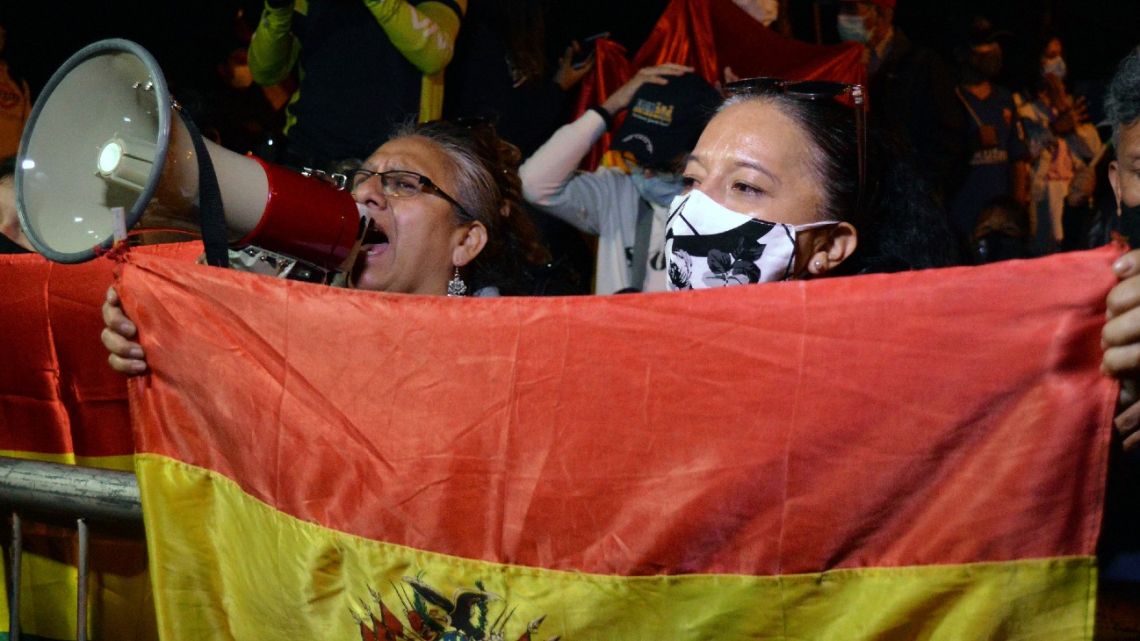 People hold a protest against the results in the country's presidential election after Luis Arce of the Movement for Socialism (MAS) party claimed victory in Sunday's election, in front of the office where departmental votes are counted, in Cochabmba on October 20, 2020.  