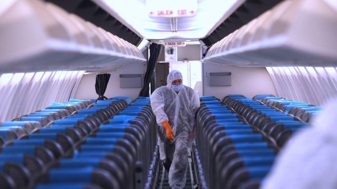 Workers disinfect an Aerolíneas Argentinas plane before it departs for Jujuy.