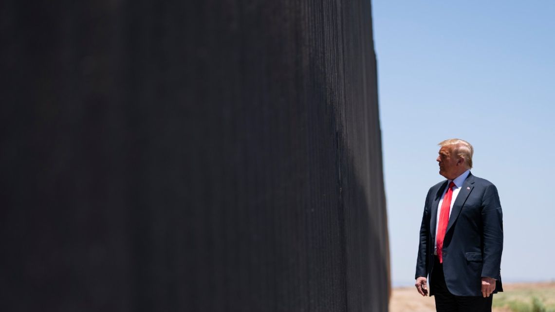 In this June 23, 2020, file photo, US President Donald Trump tours a section of the border wall in San Luis, Arizona. 