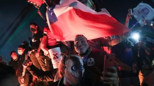People gather at Plaza Italia on the day Chileans voted in a referendum to decide whether the country should replace its 40-year-old constitution, written during the dictatorship of general Augusto Pinochet, in Santiago, Chile, Sunday, October 25, 2020.