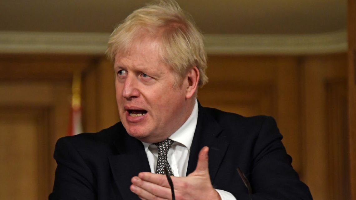 Britain's Prime Minister Boris Johnson gestures as he speaks during a press conference in 10 Downing Street, London, Saturday, Oct. 31, 2020.