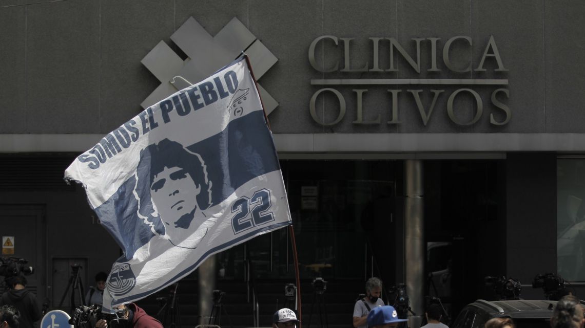 Supporters of Gimnasia y Esgrima La Plata and Diego Maradona gather outside the private clinic in Olivos, where the legendary former footballer underwent brain surgery for a blood clot.