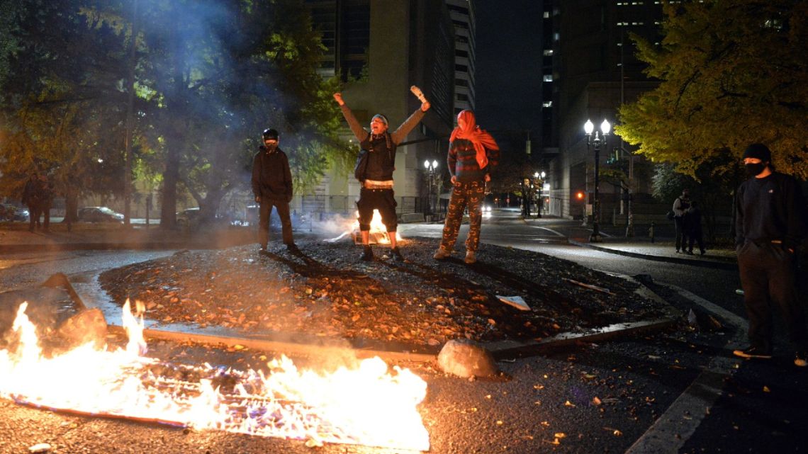 Protesters burn the American flag outside the Mark O. Hatfield United States Courthouse in Portland, Oregon, on November 4, 2020. 