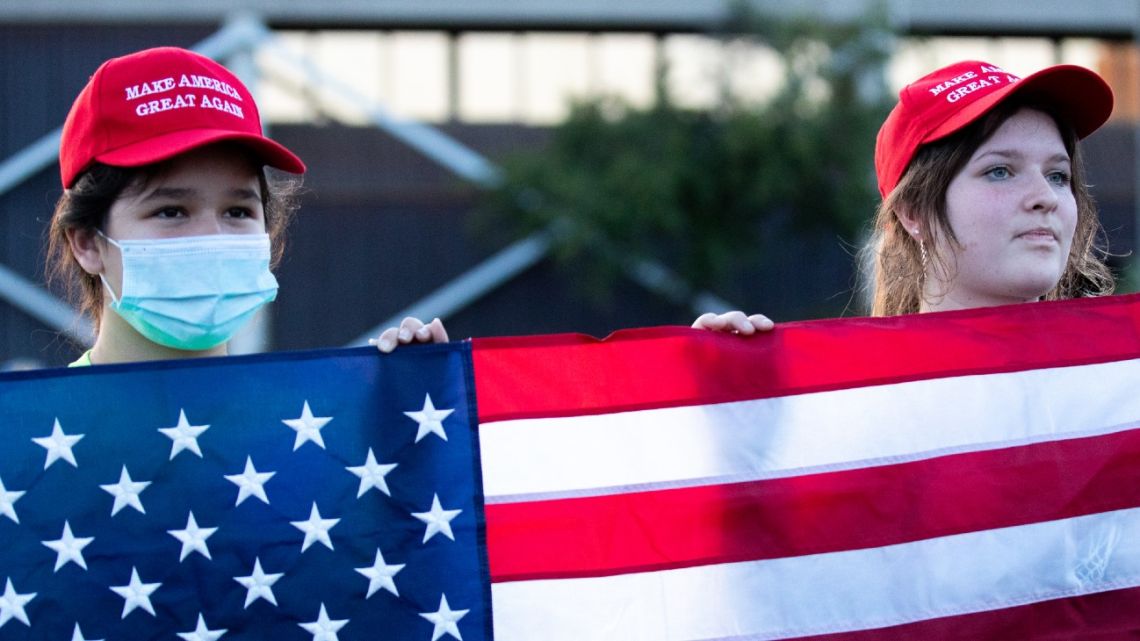 PHOENIX, AZ - Supporters of President Donald Trump hold up a flag during a protest against the election results at the Maricopa County Elections Department office on November 5, 2020 in Phoenix, Arizona. Ballots continue to be counted in many critical battleground states as the final results in the U.S. presidential election remain too close to call. 