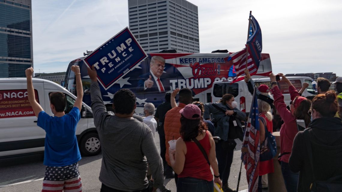 A bus drives by supporters of US President Donald Trump protest outside State Farm Arena as ballots continue to be counted inside on November 5, 2020 in Atlanta, Georgia.