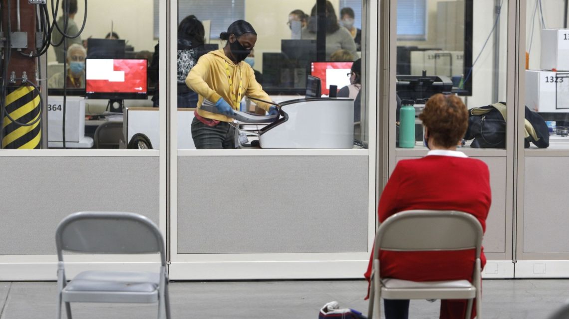 A poll watcher observes ballots being counted at the Clark County Election Department in North Las Vegas, Nevada, on November 5.