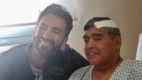 This handout photo released by the press officer for Diego Armando Maradona shows the Argentine football legend shaking hands with his doctor, Leopoldo Luque, at the Olivos clinic.