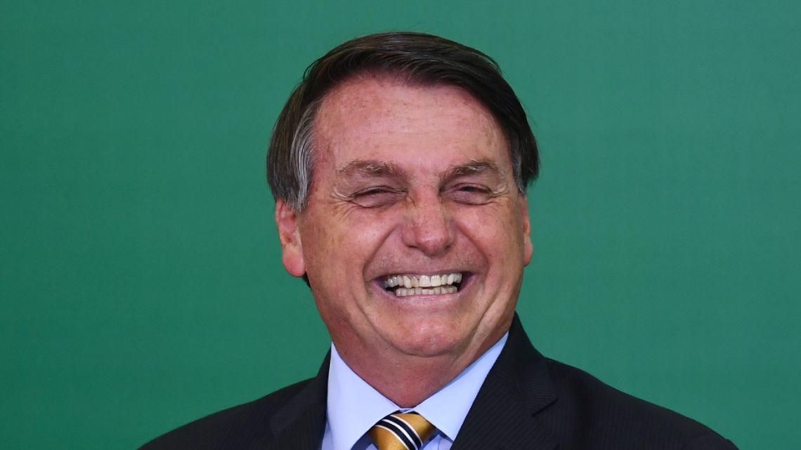 Brazilian President Jair Bolsonaro gestures during the commemoration of the 54th anniversary of the creation of Brazil's Tourism Board (EMBRATUR) at Planalto Palace in Brasilia, on November 17, 2020. 
