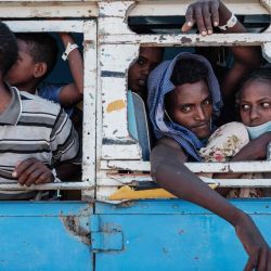 Una pareja de refugiados etíopes recién casados, Luwam Hagos, de 17 años, y Mekunnt Girmeay, de 22, que huyeron del conflicto de Tigray en Etiopía, son trasladados en autobús desde el Centro de Recepción Fronteriza al campo de refugiados de Um Raquba después de cruzar la frontera. ayer en Hamdayit, en el este de Sudán. | Foto:Yasuyoshi Chiba / AFP