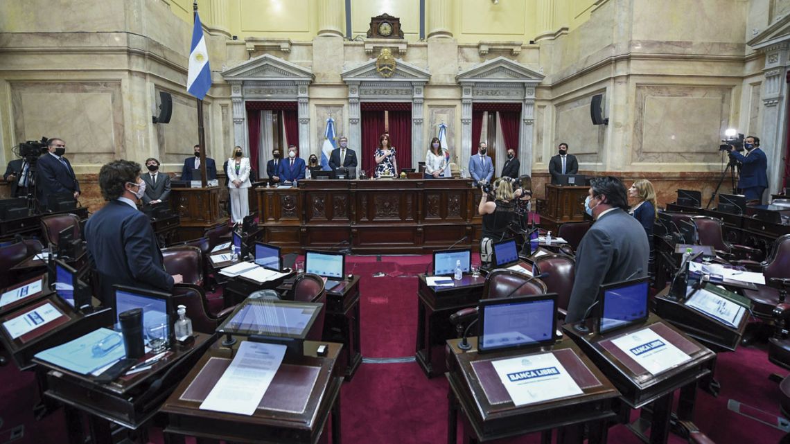 Senators stand, prior to the opening of Thursday’s session.