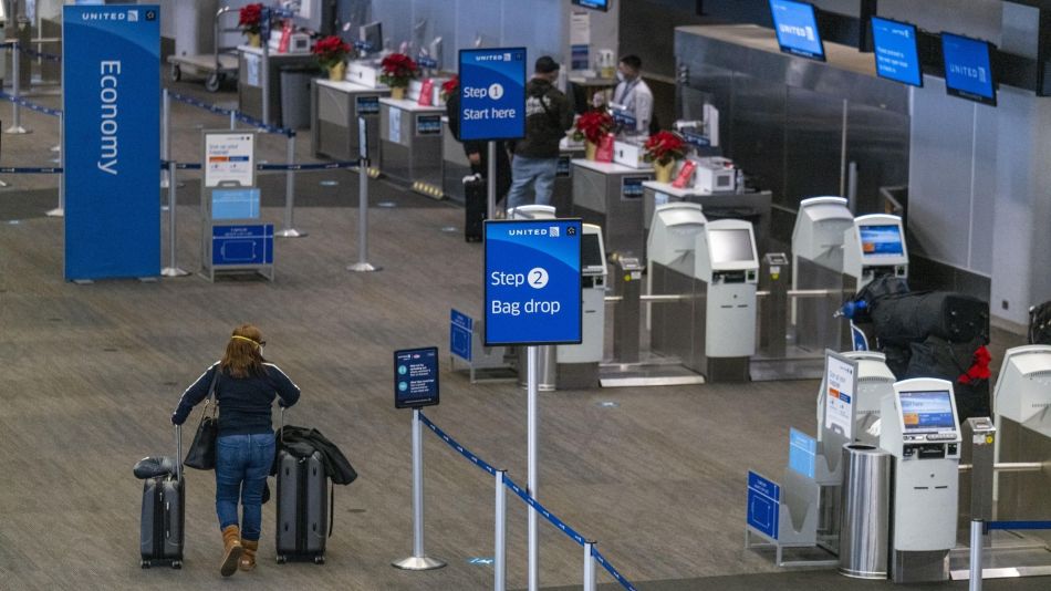 Travelers At SFO Airport Ahead Of Christmas Holiday