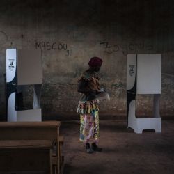 Un votante se prepara para votar en el colegio electoral de la escuela secundaria Barthélemy Boganda en el primer distrito de Bangui, República Centroafricana (CAR), durante las elecciones presidenciales y legislativas del país. | Foto:ALEXIS HUGUET / AFP