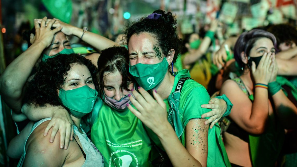 Pro-choice activists celebrate after the Senate approved a bill to legalise abortion outside the Congress in Buenos Aires on December 30, 2020. 