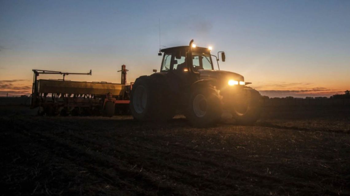 A farmer ploughs a field as the sun sets to prepare for corn planting in Rojas, Buenos Aires Province. 